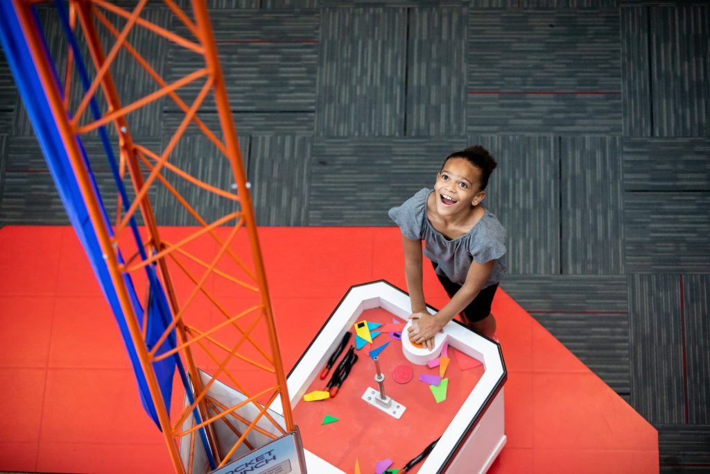 A girl interacts with a Space Place exhibit.