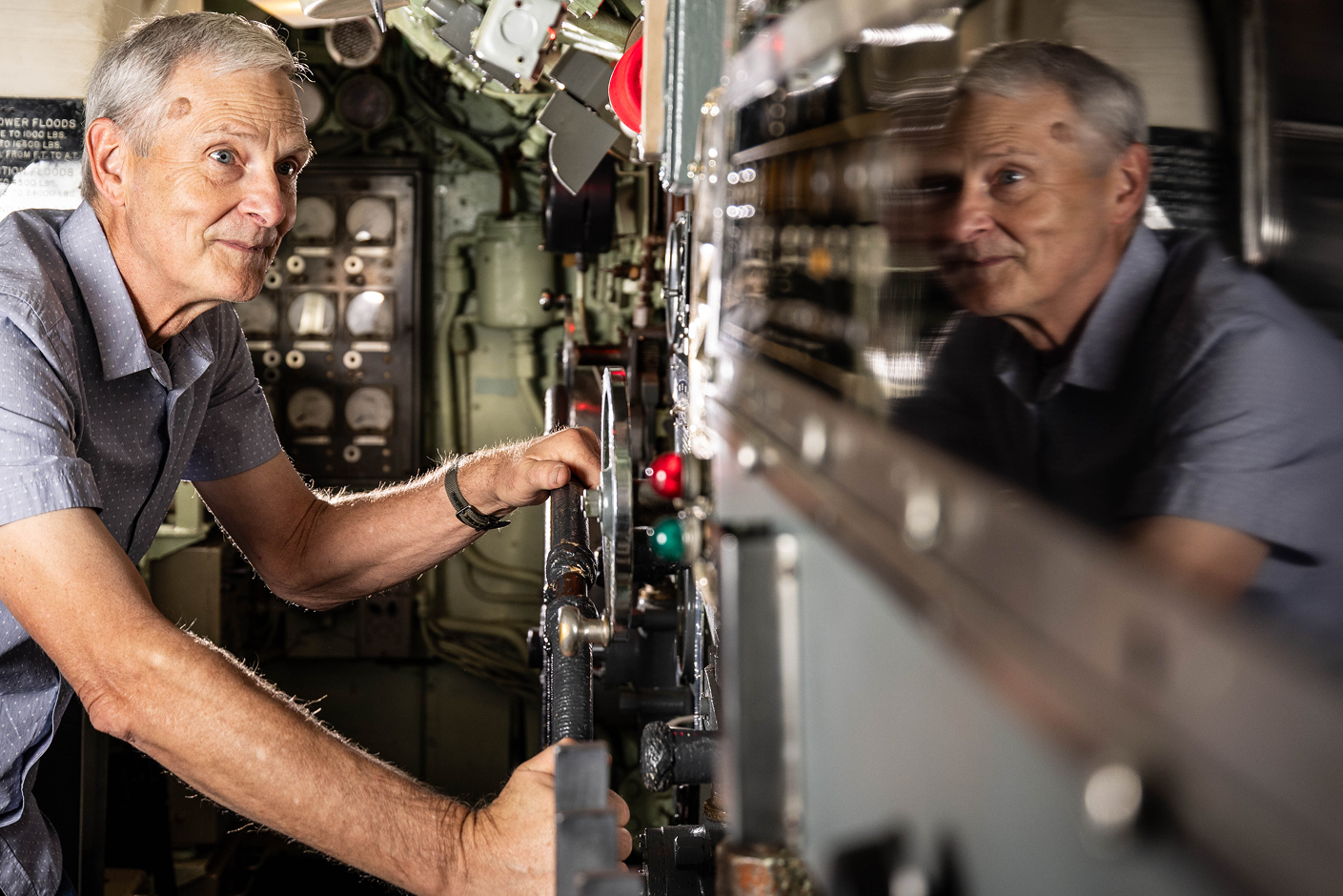 Man interacting with the inside of the USS Requin (SS 481)