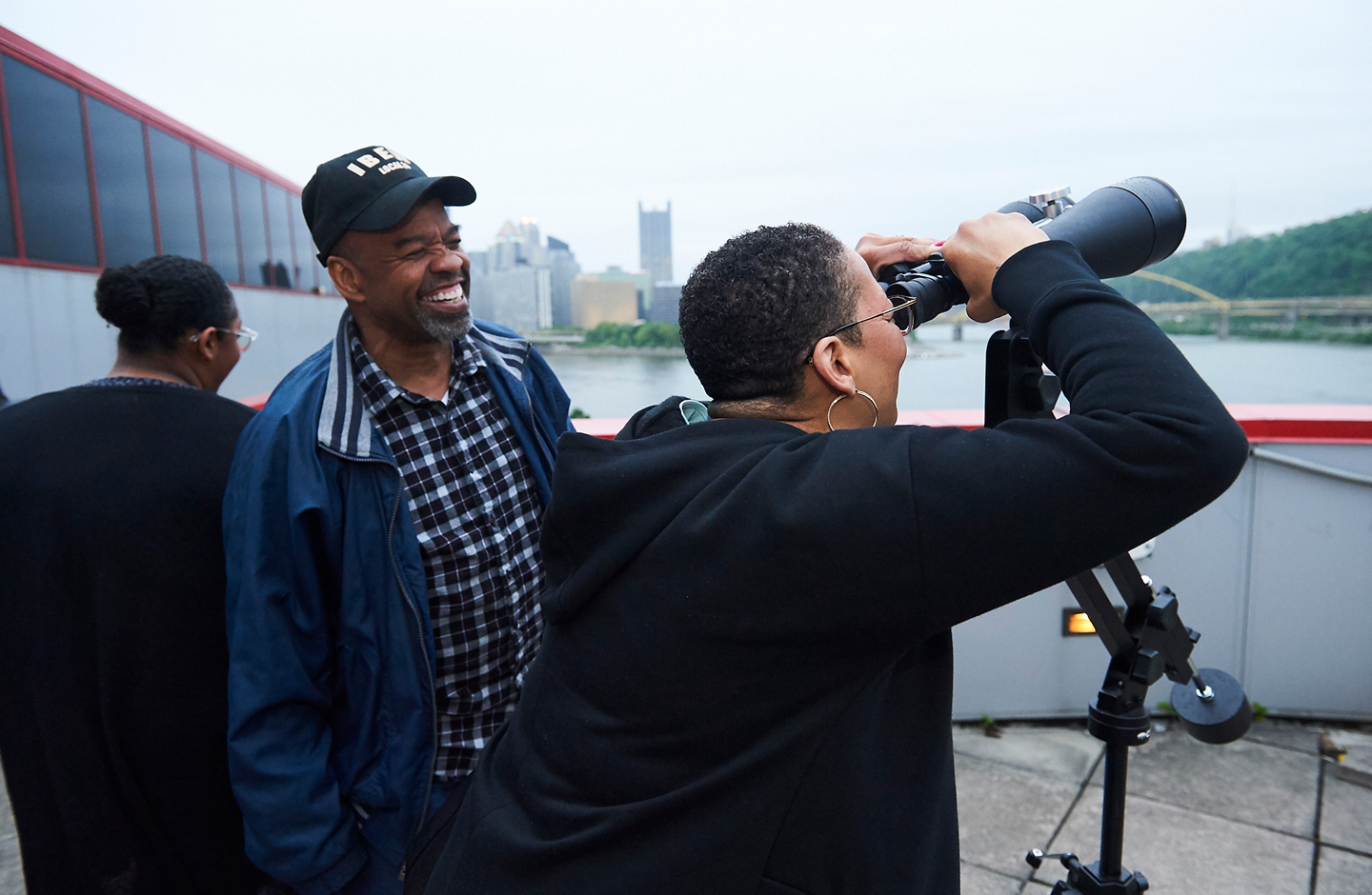 A visitor looks through a telescope to view the sky.