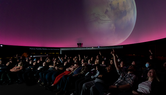 A magenta skyline during a show in the Buhl Planetarium.