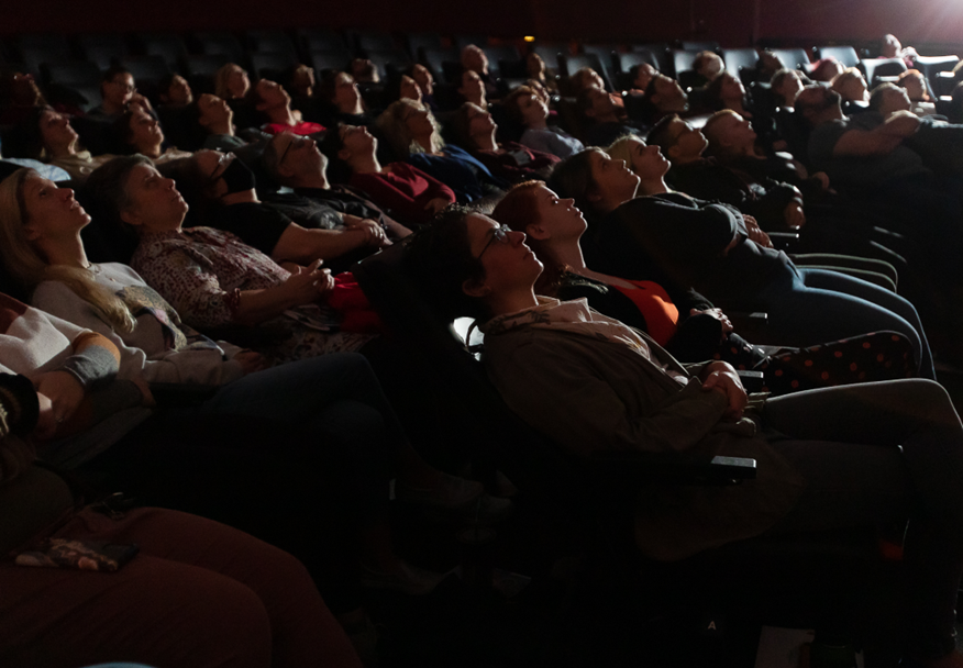 An audience is reclined in the seats at the Buhl Planetarium.