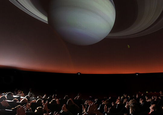 A giant image of Saturn is projected on the ceiling of the Buhl Planetarium.