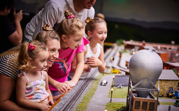 A family enjoys the tiny details in the Miniature Railroad & Village.