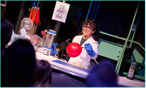 A scientist conducting an experiment with a red balloon.