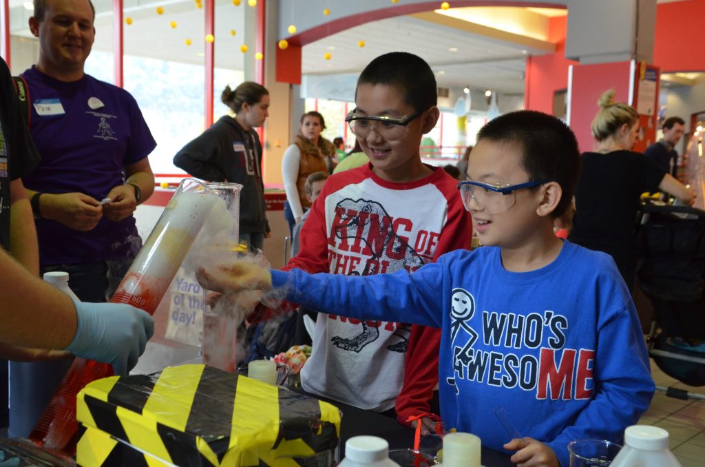 Kids interacting with a science activity