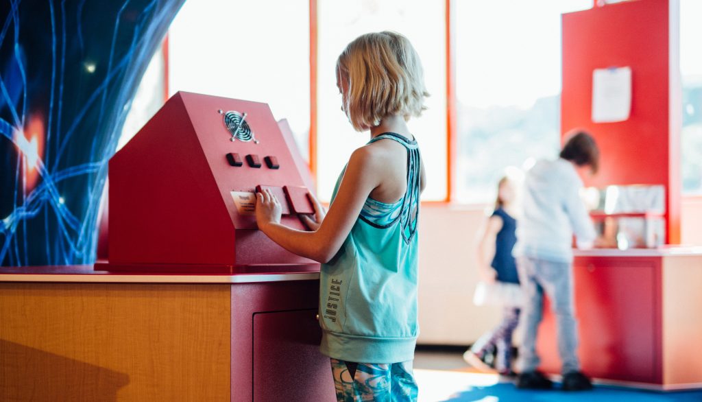 a young girl looks at an exhibit
