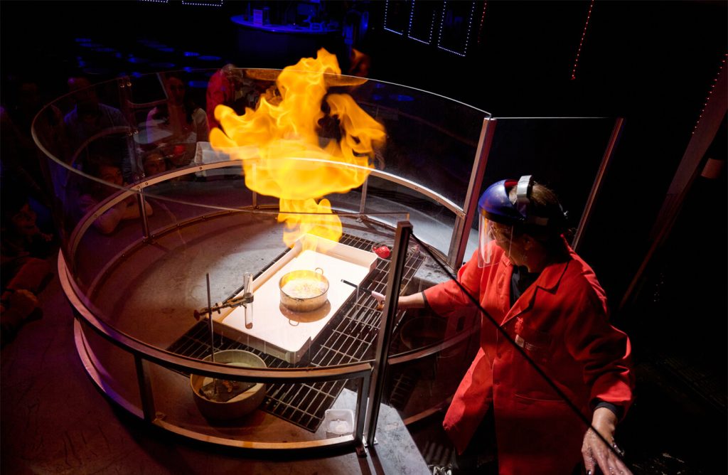 A staff member conducts an experiment in the Works Theater.