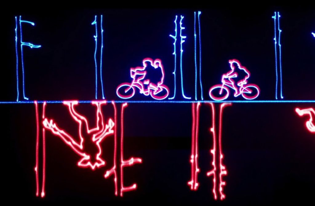 Laser show of kids on bikes