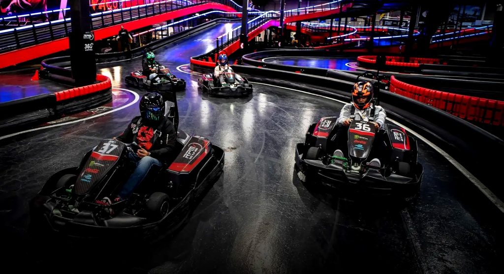 Science of Speed race track with people riding in race karts.