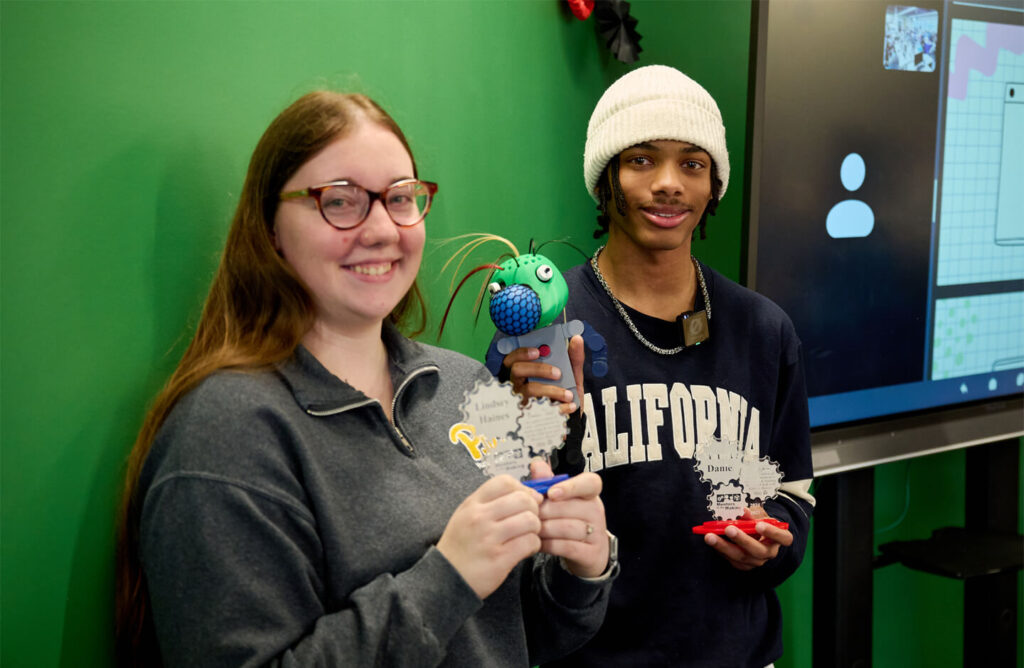 Two people showing their 3D projects