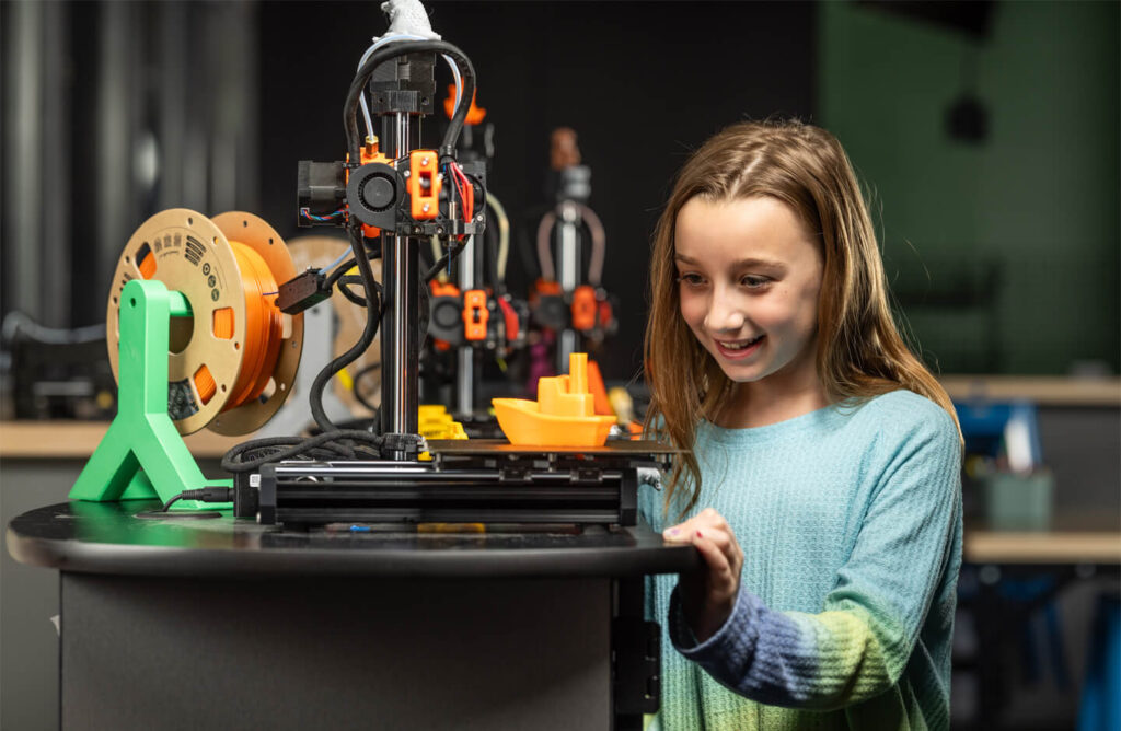 Girl using a 3D printer