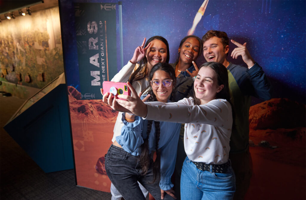 Teens take a selfie in Mars: The Next Giant Leap.