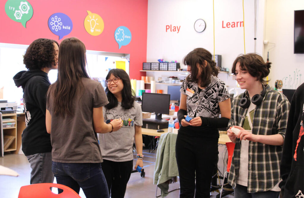 a group of teens working on projects at Fab Lab