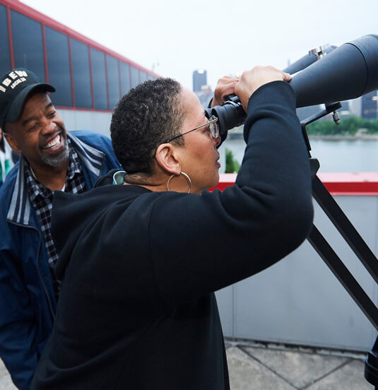 A couple looking through binoculars